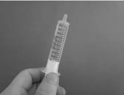 If you see bubbles of air in the oral syringe after drawing up the water, turn the oral syringe so the tip is pointing up Illustration